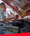 Mechanic installing Extra Guard CH10246 Spin On Engine Oil Filter For 10K Mile Change on a car engine in a garage.