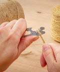 DoohicKey Keychain Multi Tool Stainless Steel 8 In 1 Bottle Opener Nail Puller Wrench Ruler in use on twine