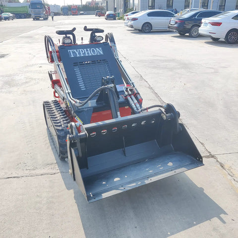 Front view of Mini Skid Steer Loader 1800 Lb Capacity With Four In One Bucket Attachment on pavement