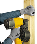 Person using multipurpose foam nitrile coated work gloves with breathable liner while holding a nail gun and wooden board, size extra large.