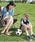 Woman sitting on Foldable Canopy Chair With Retractable Sun Shade For Camping, Tailgating, And Outdoor Events, Portable Quad Seat
