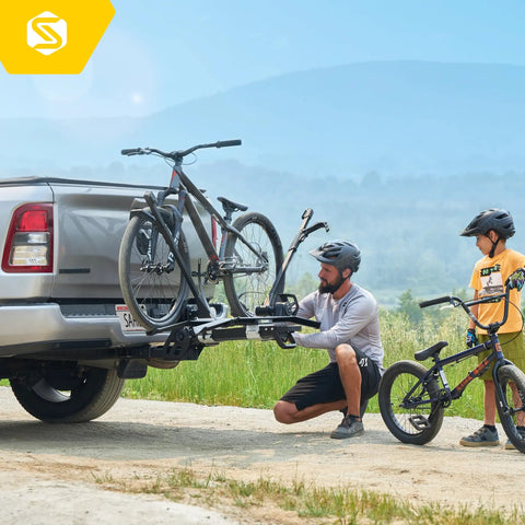 Man installs Modular Two In One Hitch Rack For Two Bikes Up To Eighty Pounds Tilts And Folds For Easy Storage on SUV