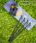 Heavy Duty Tent Stakes 12 Inch Pack Of 4 With Camp Rope Guy Lines And Storage Bag on grass