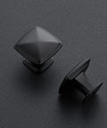 Single Hole Square Kitchen Cabinet Knobs In Matte Black, 25 Pack, Modern Euro Style Hardware To Upgrade Your Cabinets, Durable Metal Construction, Easy Install, Ideal For Kitchens, Bathrooms, And Dressers. Close-up of matte black square metal cabinet knobs