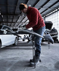 Person working in a garage with GS4200EP 13,000 BTU Propane Tank Top Heater Built For Outdoors, Tough Jobsites, and Campsites in use.