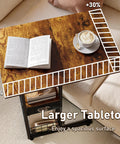 C-Shaped Side Table With Wheels And Large Wood Top, showing open book and coffee cup on wooden tabletop near sofa.