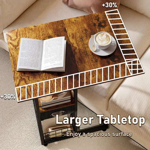 C-Shaped Side Table With Wheels And Large Wood Top, showing open book and coffee cup on wooden tabletop near sofa.