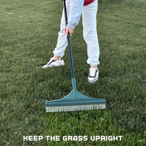 Person using Artificial Turf Rake For Pet Hair, Leaves And Debris, Adjustable 63 Inch Telescoping Handle on artificial grass.