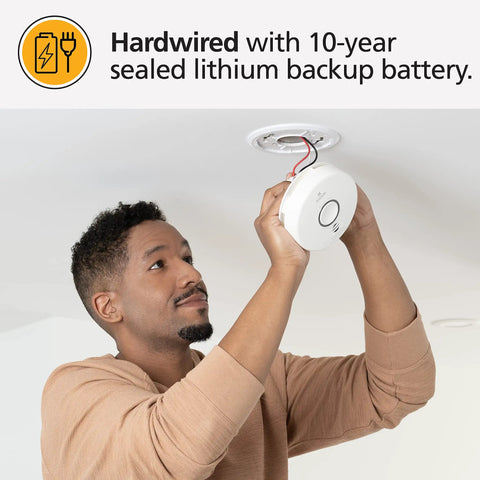 Top Shelf Smart Smoke Detector Delivering Wifi Connectivity Alexa Integration Hardwired Design With Battery Backup Voice And App Alerts Rock Solid Home Defense No Sweat Install Two Pack being installed by a person on the ceiling.