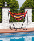 Hanging Hammock Chair With Space Saving Stand For Indoor And Outdoor Use 330 Pound Capacity Sunset Cotton Seat beside pool.