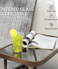 Close-up of Two Person Outdoor Glider Bench With Built In Table For Patio Hangout showing tempered glass table with drink and book.