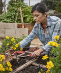 Gardener using Premium Stainless Steel ComfortGEL All In One Hoe Cultivator With Comfy Grip in vegetable garden, rust-resistant