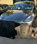 Crush Proof Hydroformed Aluminum Skid Plates For Tesla Model Y Front And Rear With Thick Acoustic Foam To Zero Out Road Noise And Shield Critical Axles During Rough Drives 2020 To 2025 displayed in front of a Tesla Model Y.