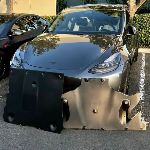 Crush Proof Hydroformed Aluminum Skid Plates For Tesla Model Y Front And Rear With Thick Acoustic Foam To Zero Out Road Noise And Shield Critical Axles During Rough Drives 2020 To 2025 displayed in front of a Tesla Model Y.
