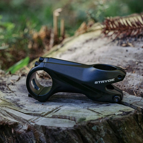 Stryge Drop Stem For 35mm Handlebars, -5 Degree Drop, 75mm Length, 35mm Bar Clamp on forest log showcasing design