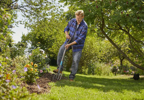 Man using the Nature Line Spading Fork for Quick, No-Fuss Root-Safe Digging and Loosening Soil in Garden Beds, Heavy-Duty Hardened Steel Tines.