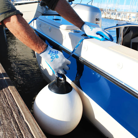 Person using Original 1994 Crinkle Grip Work Gloves With Natural Latex Palm, Blue, Small, securing a boat fender.