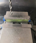 Close-up of Magnetic Parallel Keepers For Vise And CNC Machining with aluminum build and blue powder coat, attracting ferrous chips.