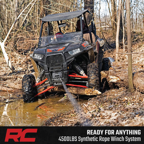 Rough Country 4500 Lb ProSeries Winch For Utv And Atv With Fifty Ft Synthetic Rope 1.4HP Motor 12V waterproof remote control used in muddy terrain.
