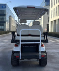 Smooth 48V Lithium Golf Cart Sightseeing Patrol Rig with solid double wishbone suspension, showing back seats and rear view in urban setting.