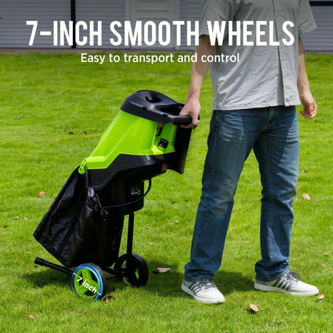 Person using Powerful 15 Amp Electric Wood Chipper And Mulcher For Yard Work with 7-inch wheels on grass