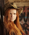 Woman wearing Upcycled Tarp Hat From Brazil With Shapeable Brim And Ventilated Burlap Crown For Sun Protection Breathable Comfort