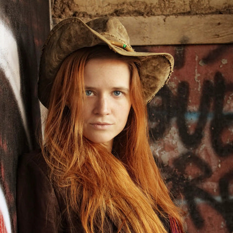 Woman wearing Upcycled Tarp Hat From Brazil With Shapeable Brim And Ventilated Burlap Crown For Sun Protection Breathable Comfort