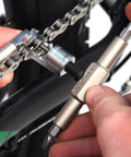 Mountain Bike Tool Kit With Replaceable Sticks And Bracket Two Tire Levers Eight Bits Chain Breaker in use on bike chain