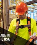 Worker in orange hard hat and safety gear, inspecting construction site, showcasing Cap Style Construction Hard Hat With Four Point Suspension Built Tough For Work OSHA And ANSI Z89 Compliant Class G And Class E Safety Helmet Made In USA White Durable Gear For Men And Women, with USA-made label visible.