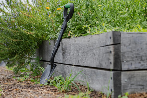Mini Digging Shovel Built Tough With Heavy Duty Carbon Steel Head And Serrated Blade, Ergonomic No Slip H Grip And D Handle next to garden