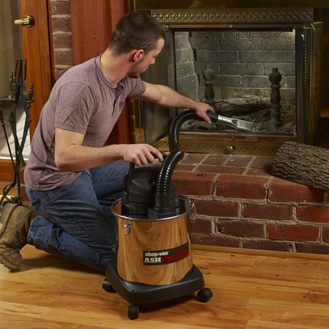 Person using Heavy Duty Beast 5 Gallon Ash Dry Vacuum With Stainless Steel Tank, 4 Peak HP, 1.5 Inch Diameter And 4 Foot Hose