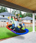 Kids enjoying 66 Inch Oval Saucer Swing For Kids And Teens Outdoor Indoor Backyard Fun With Adjustable Ropes Durable Seat