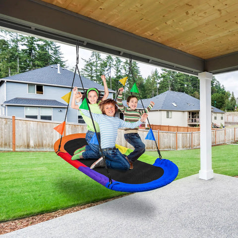 Kids enjoying 66 Inch Oval Saucer Swing For Kids And Teens Outdoor Indoor Backyard Fun With Adjustable Ropes Durable Seat