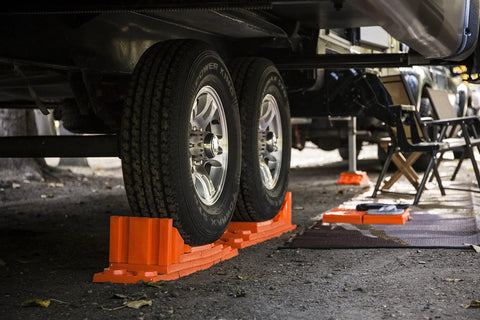 Stop N Chock 2 Pack For No Fuss Safe Parking And Easy Stabilization Interlocks With Levelers Durable Porous PLA Construction Delivers Strong Grip And Quick Setup installed under RV wheels on gravel