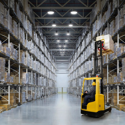 Heavy Duty 200W Led High Bay Shop Light With Motion Sensor illuminating warehouse aisle with yellow forklift and pallets.