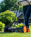 Man using Old School 18 Inch Manual Reel Mower With 7 Blade Ball Bearing Reel Push Style Adjustable Cutting Height on lawn