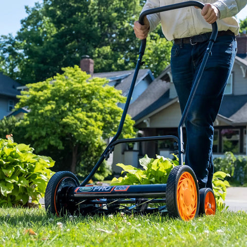 Man using Old School 18 Inch Manual Reel Mower With 7 Blade Ball Bearing Reel Push Style Adjustable Cutting Height on lawn