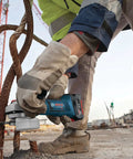 Worker using 18V Cordless Angle Grinder 4-1/2 Inch Bare Tool to cut rebar, showcasing all-day power and electronic protection features.