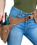 Full-Grain Leather Garden Utility Belt For Women with tools, worn over jeans, buckle and 3 pockets visible
