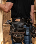 Heavy Duty Tool Belt And Rig With TrapJaw Pockets on carpenter's waist, pro organizer for 50-inch adjustable fit, black and brown design.