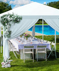 Outdoor Gazebo Canopy Tent With Removable Sidewalls And Windows For Parties, Weddings, And Events Waterproof Shelter With Rust Resistant Steel Frame Easy Setup Party Ready And 10x10, 10x20 Or 10x30 Ft Size Options on grass with chairs and table