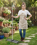 Heavy Duty Lawn Leveling Rake With Aluminum Rollers 40x10 Inch Adjustable Handle 27 To 80 Inch Stainless Steel Ground Leveler used by woman in garden.