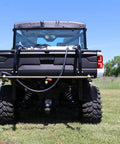 Rear view of 50 Gallon UTV Broadcast Sprayer With Precision And Boomless Booms Up To 30 Foot Swath 3 GPM EZ Lock Boom Mount on grass