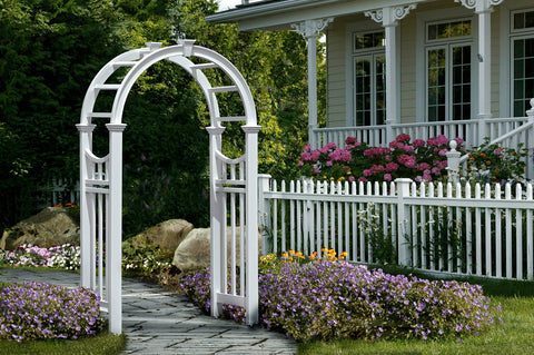 Durable White Vinyl Arbor For Outdoor Garden Pathway 49 Inch Wide By 91 Inch High, No-Fuss Low Maintenance, shown amidst garden flowers.
