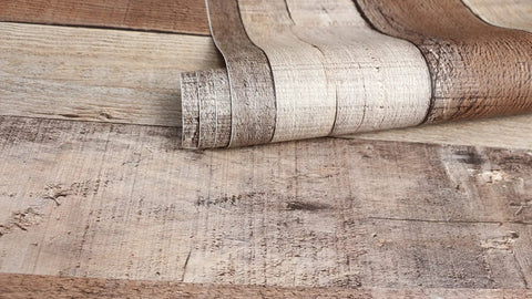 Close-up of rolled Cinnamon Wood Peel And Stick Wallpaper Self Adhesive Faux Wood Plank For Kitchen Counter And Home Decor.