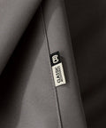 Close-up of fabric texture and brand label on Ravenna Water Resistant 58 Inch Patio Sofa Loveseat Cover Small Taupe Outdoor Furniture Cover.