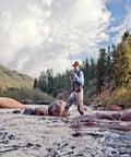 Angler wearing Ultra Lightweight Fly Fishing Vest With 14 Pockets And Front Zip Storage Olive Green on riverbank