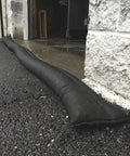 Water Activated 10ft Flood Barrier Pack Of 8 Reusable Absorbers protecting doorway from rain outside a building