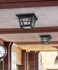 Herrington Two Light Outdoor Ceiling Flush Mount Fixture in black finish installed on patio ceiling