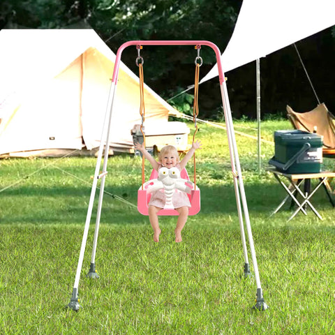 Child using 3-In-1 Toddler Swing Set With Metal Stand For Indoor Outdoor Use in backyard, pink baby seat, camping tents in background